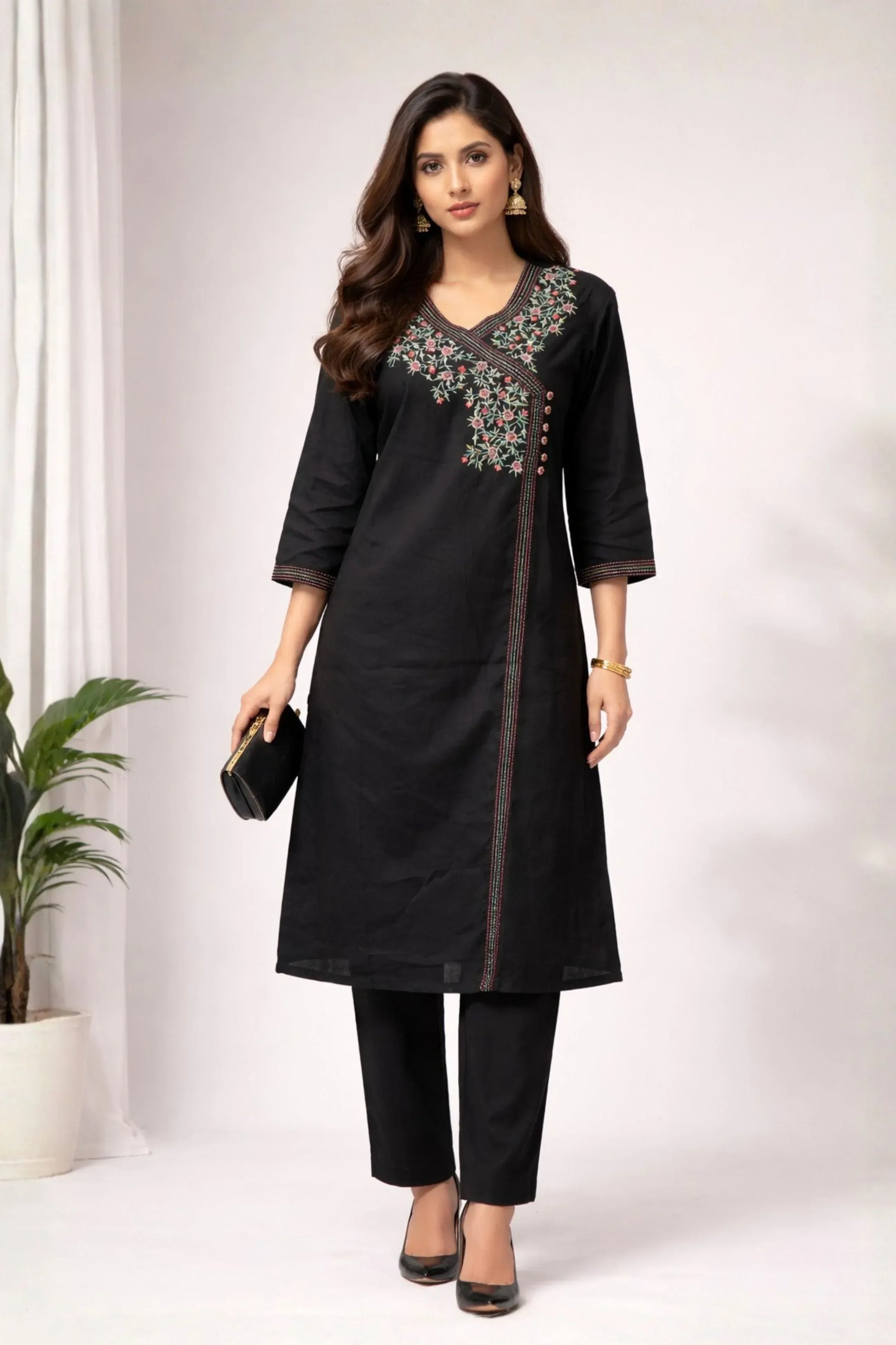 Black embroidered two-piece co-ord set with intricate floral detailing on a white background.