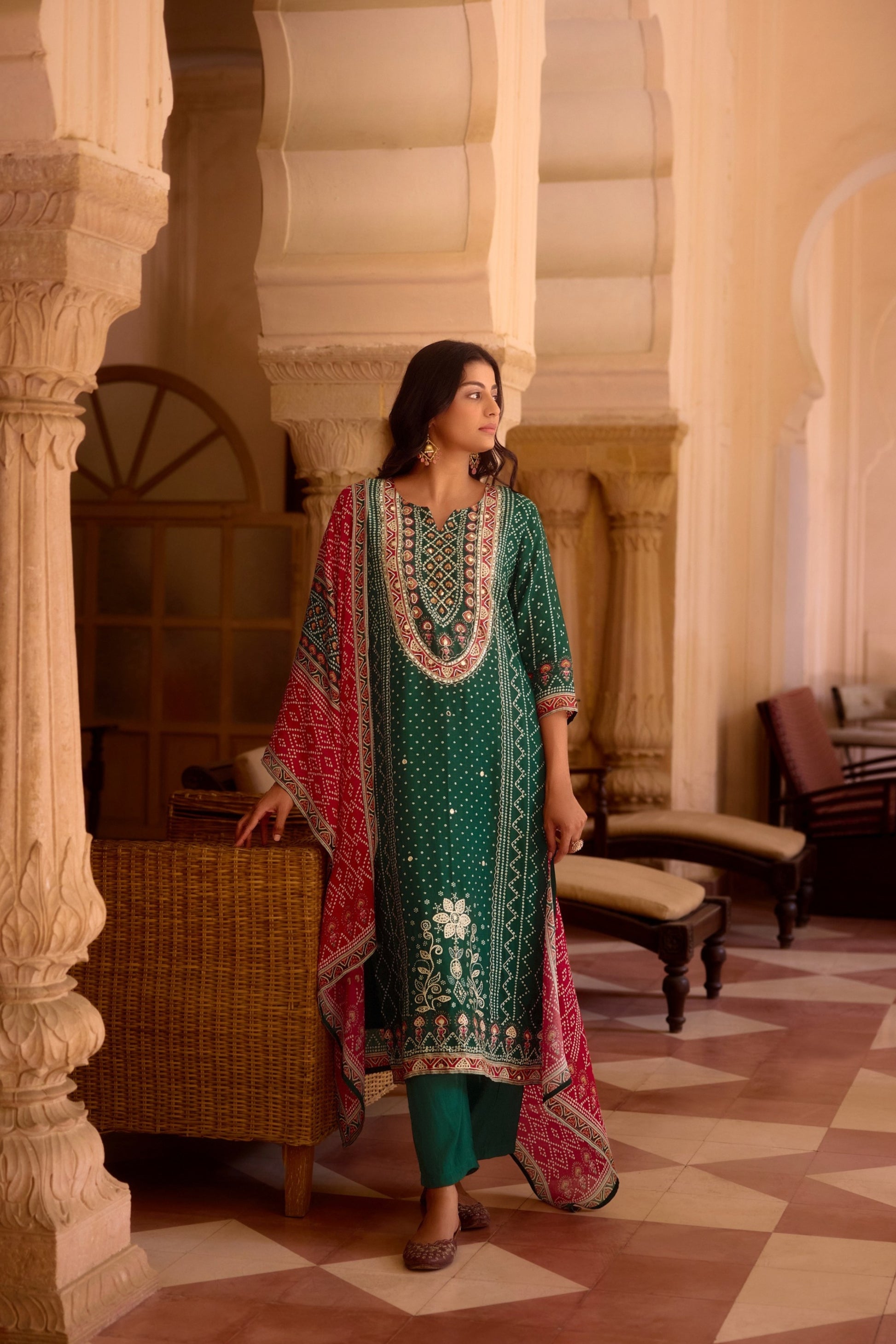 Emerald green Bandhej kurta set with mirror work, paired with an Ajrakh print dupatta.
