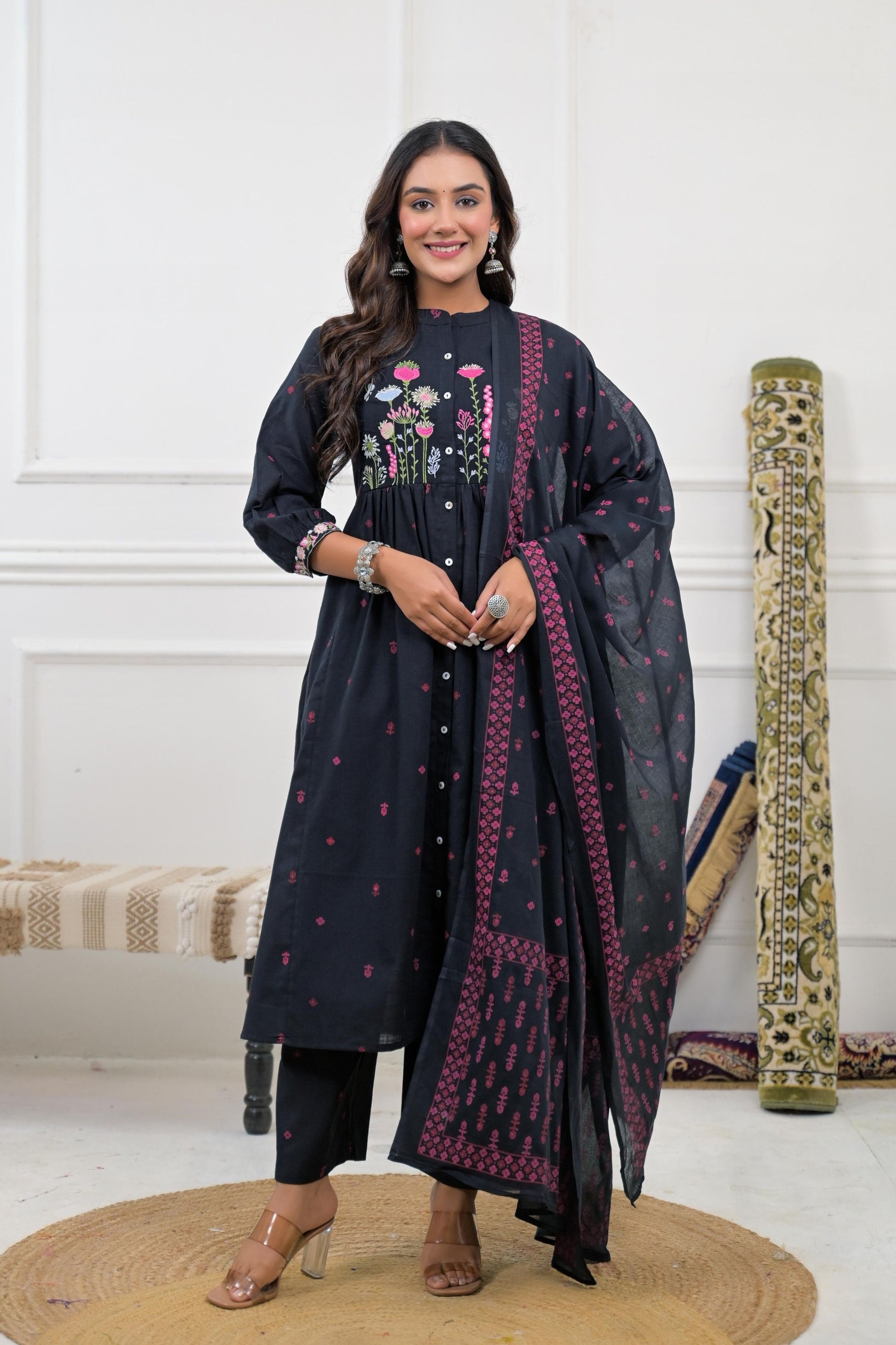 Floral embroidered kurta set with dupatta, featuring intricate floral patterns on a vibrant fabric.