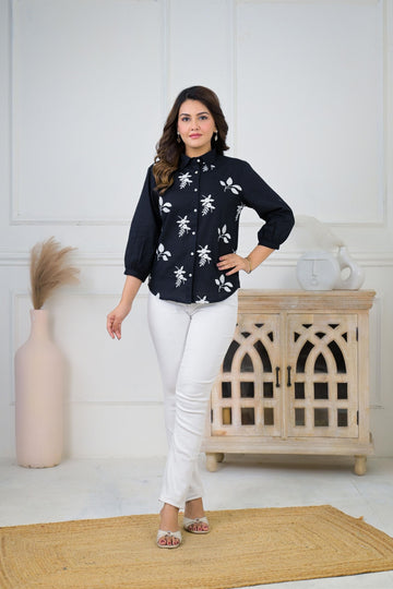 Floral embroidered button-down shirt for women, featuring intricate floral embroidery on a light-colored fabric.