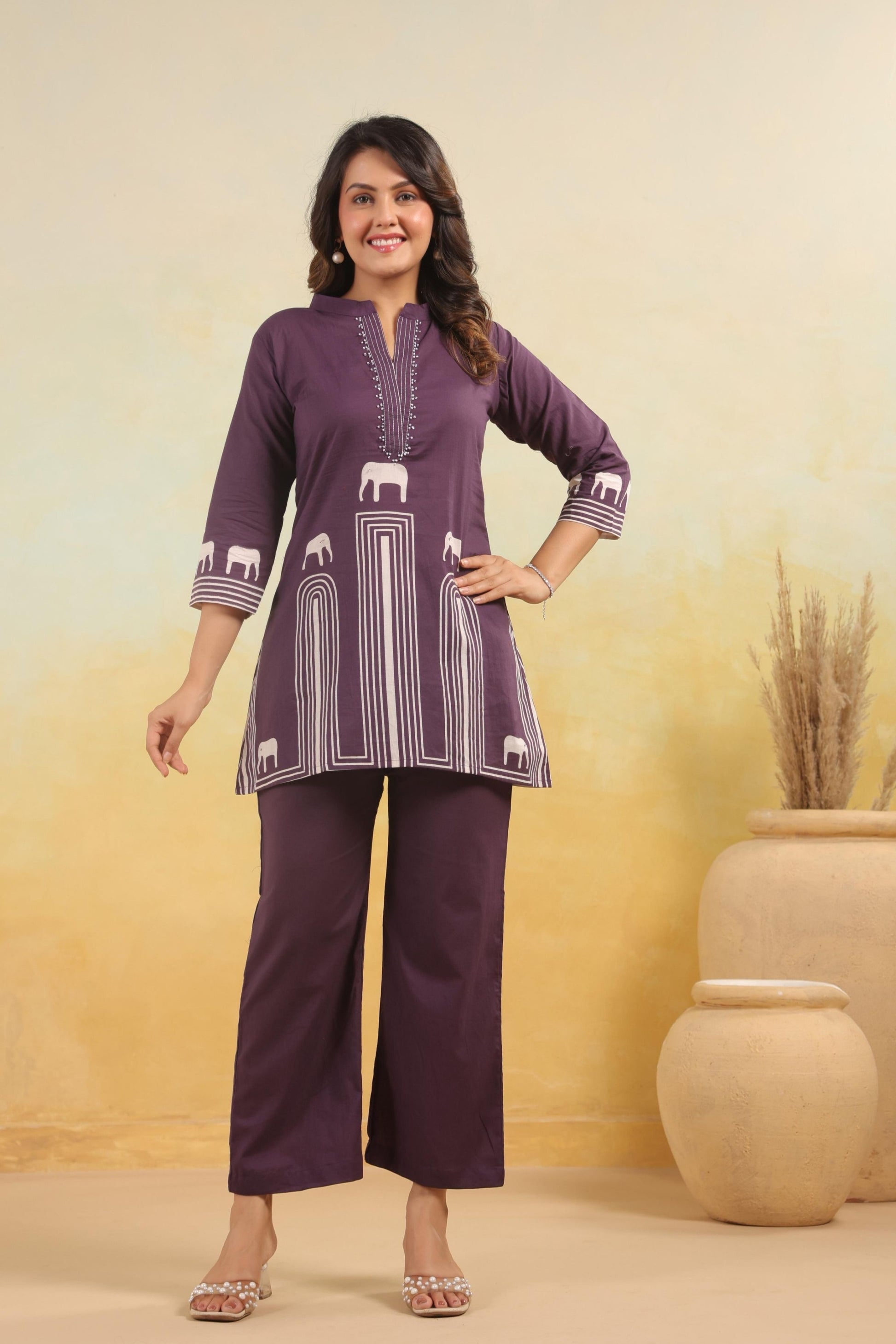 Elephant motif printed kurta set for women in a vibrant red hue, featuring intricate elephant designs and a matching dupatta.
